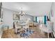 Open-concept dining area with a chandelier, round table and seating for four at 300 Glennes Ln # 203, Dunedin, FL 34698