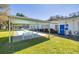 Well-maintained exterior features covered area with bench and bocce ball court at 300 Glennes Ln # 203, Dunedin, FL 34698