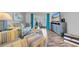 Cozy living room features striped furniture, wood floors, and sliding glass doors to outdoor area at 300 Glennes Ln # 203, Dunedin, FL 34698