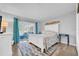 Comfortable main bedroom with natural light and sliding glass door to the sunroom at 300 Glennes Ln # 203, Dunedin, FL 34698