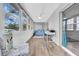 Beautiful sunroom features an abundance of natural light, desk and comfortable furniture at 300 Glennes Ln # 203, Dunedin, FL 34698