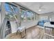 Inviting sunroom with large windows, ceiling fan, and comfortable seating at 300 Glennes Ln # 203, Dunedin, FL 34698