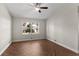 Bright bedroom featuring a ceiling fan and herringbone floors provides a comfortable space at 306 Oakwood Blvd, Oldsmar, FL 34677