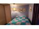 Comfortable bedroom with a colorful quilt, nautical decor, and a relaxing atmosphere at 4641 Orange Blossom Dr, Zephyrhills, FL 33542