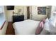 Bedroom featuring hardwood floors, light walls, and a full-length mirror at 4710 22Nd N Ave, St Petersburg, FL 33713