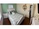Cozy bedroom with hardwood floors, a decorative shelf, and a comfortable-looking bed at 4710 22Nd N Ave, St Petersburg, FL 33713