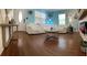 Bright living room with hardwood floors, comfortable white seating, and a white front door at 4710 22Nd N Ave, St Petersburg, FL 33713