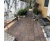 Charming walkway with brick pavers, lush landscaping, and a bench for enjoying the outdoors at 4710 22Nd N Ave, St Petersburg, FL 33713