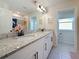 Bright bathroom featuring double vanity with granite countertop and modern fixtures at 5240 Suncatcher Dr, Wesley Chapel, FL 33545