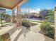 Charming front porch featuring textured concrete, stone pillars, and serene outdoor seating at 5240 Suncatcher Dr, Wesley Chapel, FL 33545