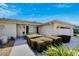 Well-maintained home featuring manicured hedges and a welcoming entryway with walkway at 612 Allegheny Dr, Sun City Center, FL 33573
