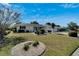 Charming single-story home featuring a well-manicured lawn and beautiful landscaping at 612 Allegheny Dr, Sun City Center, FL 33573