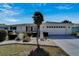 Attractive single-story residence featuring a pristine lawn, manicured landscaping, and a spacious driveway at 612 Allegheny Dr, Sun City Center, FL 33573