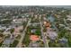 Aerial view of a neighborhood and waterway featuring a home with an orange tile roof and screened-in pool at 710 Treasure Boat Way, Sarasota, FL 34242