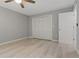 Bedroom features include ample closet space, ceiling fan, and light wood-look flooring at 710 Treasure Boat Way, Sarasota, FL 34242
