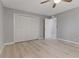 Bedroom with a large closet, neutral paint, ceiling fan and light wood-look floors at 710 Treasure Boat Way, Sarasota, FL 34242