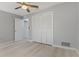 Bedroom with a large closet, neutral paint, ceiling fan and light wood-look floors at 710 Treasure Boat Way, Sarasota, FL 34242