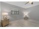 Bedroom features include a window with blinds, ceiling fan, and light wood-look flooring at 710 Treasure Boat Way, Sarasota, FL 34242