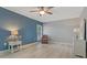 Bedroom with neutral walls, light wood-look floors, an accent wall, and side tables with lamps at 710 Treasure Boat Way, Sarasota, FL 34242
