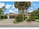 Inviting single-story home with tile roof, brick-paved driveway, lush landscaping, and a two-car garage at 710 Treasure Boat Way, Sarasota, FL 34242