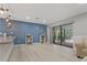 Relaxing living area with sliding glass doors leading to the screened lanai and outdoor space at 710 Treasure Boat Way, Sarasota, FL 34242