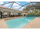 Private enclosed pool with shaded lanai and outdoor seating at 710 Treasure Boat Way, Sarasota, FL 34242