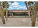 Backyard with a private screened-in pool and mature palm trees at 710 Treasure Boat Way, Sarasota, FL 34242