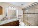 Updated bathroom features a granite vanity and a tiled shower with glass door at 8019 Capwood Ave, Temple Terrace, FL 33637