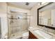 Updated bathroom featuring a glass shower enclosure, granite countertop, and tile floors at 8019 Capwood Ave, Temple Terrace, FL 33637