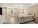 Cozy bedroom with neutral walls, updated flooring, large windows, and a chandelier at 8019 Capwood Ave, Temple Terrace, FL 33637