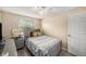 Cozy bedroom features a grey bed frame and a window with natural light at 8019 Capwood Ave, Temple Terrace, FL 33637