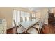 Elegant dining room featuring a modern chandelier, stylish furniture, and hardwood floors for sophisticated gatherings at 8019 Capwood Ave, Temple Terrace, FL 33637