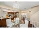 Bright kitchen with stainless steel appliances, granite countertops, leading to an adjacent formal dining area at 8019 Capwood Ave, Temple Terrace, FL 33637