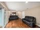 Spacious living room boasting hardwood floors, comfortable seating, and abundant natural light, ideal for relaxation at 8019 Capwood Ave, Temple Terrace, FL 33637