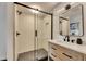 Modern bathroom boasts glass shower, wood vanity, and contemporary fixtures at 8204 Stoner Rd, Riverview, FL 33569