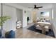 Well-lit bedroom with bed, blue rug, neutral walls and a fan at 8204 Stoner Rd, Riverview, FL 33569