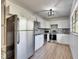Modern kitchen with stainless steel appliances, white cabinets, and tiled backsplash at 8204 Stoner Rd, Riverview, FL 33569