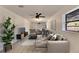 Spacious living room with large couch, ceiling fan, and natural light at 8204 Stoner Rd, Riverview, FL 33569