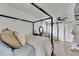 Main bedroom features four poster bed, ceiling fan, and barn doors at 8204 Stoner Rd, Riverview, FL 33569