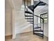 Black metal spiral staircase leading to upper level, with window views at 8204 Stoner Rd, Riverview, FL 33569