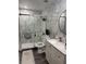 Elegant bathroom showcasing a glass-enclosed shower, a stylish sink vanity, and marble-style tiling for a spa-like experience at 8706 N Boulevard, Tampa, FL 33604