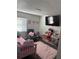 Inviting bedroom featuring a cozy chair, a flat-screen TV, playful decor, and a relaxing atmosphere at 8706 N Boulevard, Tampa, FL 33604