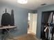 Bedroom featuring a closet, neutral walls, a view into the bathroom, and an ironing board for convenience at 8706 N Boulevard, Tampa, FL 33604