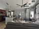 Open-concept living room with sleek fans, and a view into the kitchen and dining areas at 8706 N Boulevard, Tampa, FL 33604