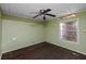 Green-painted bedroom, featuring sturdy floors and a cozy ceiling fan at 9435 Ottawa St, New Port Richey, FL 34654