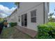 Exterior view of the home with access to the patio from the sliding glass door, overlooking the backyard at 1002 Vineyard Ln, Oldsmar, FL 34677