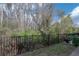 View of the backyard, featuring a wooded area, landscaping, and patio area with outdoor seating at 1002 Vineyard Ln, Oldsmar, FL 34677