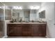 Bathroom featuring a double vanity with granite countertops and a glass-enclosed shower at 1002 Vineyard Ln, Oldsmar, FL 34677