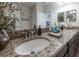 Bathroom vanity features double sinks with granite countertops and neutral color palette at 1002 Vineyard Ln, Oldsmar, FL 34677