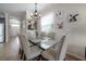 Dining room showcasing a glass-top table with seating for six and views of the home's entryway at 1002 Vineyard Ln, Oldsmar, FL 34677